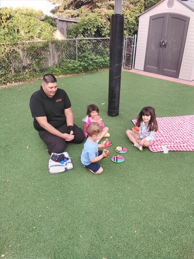 Staff with Children Eating Snack CPC Albuquerque Childcar