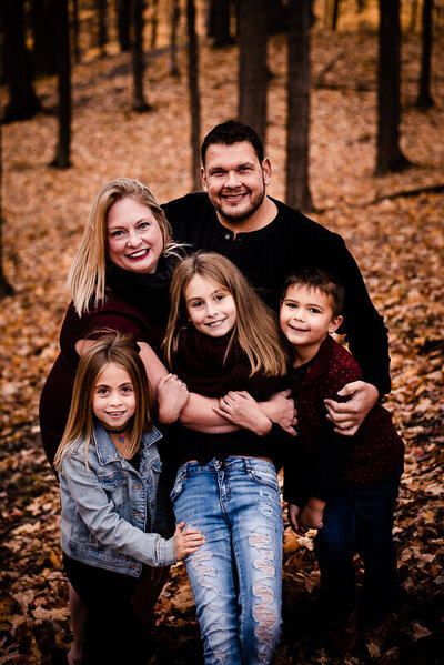 Family posing for fall photography in oshawa.
