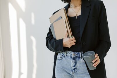 Kristina from Kmotion, a Showit website designer, at her desk with all of her creative tools.