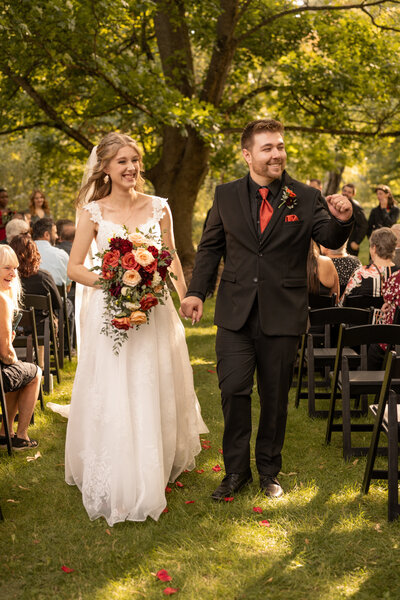 Bride and groom walking down the isle after being married taken by Idaho wedding photographer.