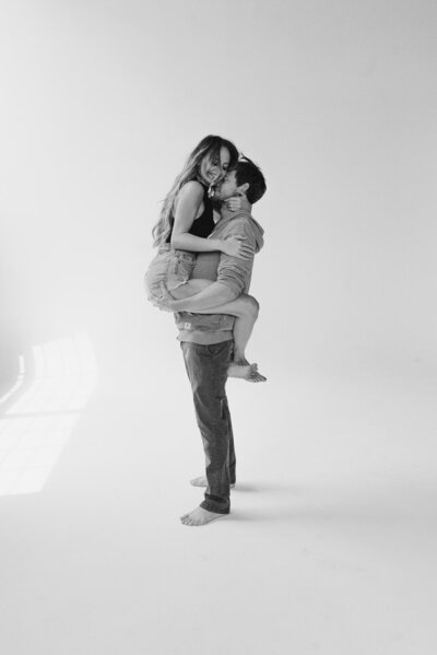 Man holding woman up during couple studio session