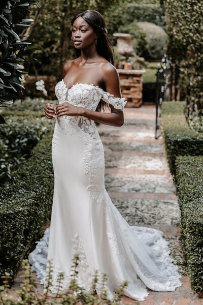We adore the gorgeous contrast between a demure high neckline and long sleeves paired with a jaw-dropping open back.