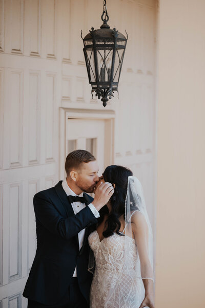 newlyweds kiss under chandelier