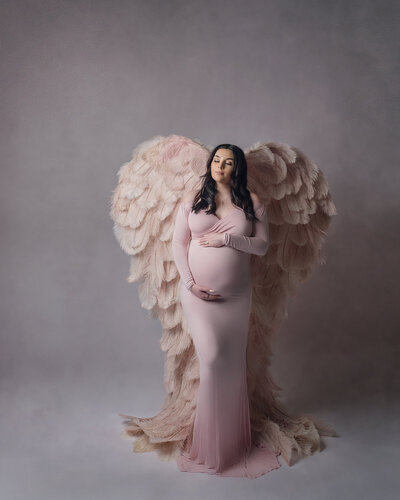 Beautiful young mother to be wearing wings for a maternity session in Southern Oregon
