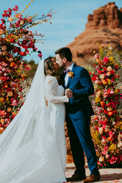 bride and groom miss at alter of red agave resort in sedona