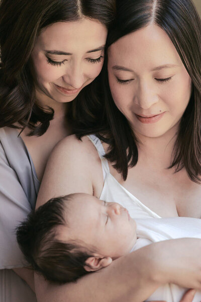 Bay area newborn family photography of moms holding newborn, taken by Laurel Smith Photography