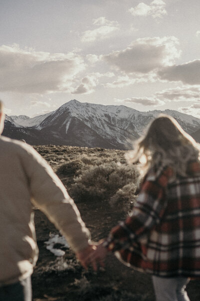 Couple walking towards the Colorado mountains