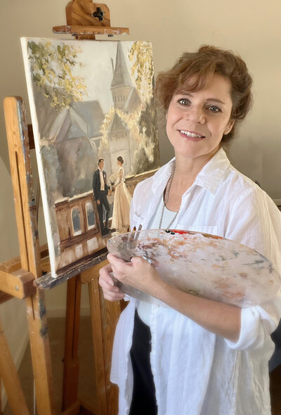 linda marino at the easel with a wedding painting in progress
