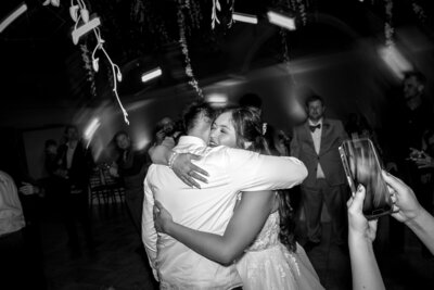 A newlywed couple shares a romantic dance at Casa Real at Ruby Hill Winery, surrounded by elegant lighting and a warm, intimate atmosphere in Pleasanton, CA.