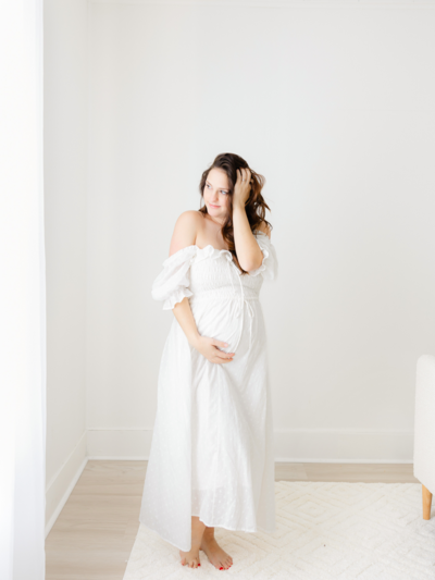 mom holds newborn baby and dad holds toddler during boston newborn photography session