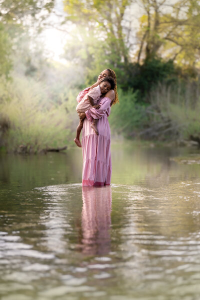 photo of mom and son standing in a river during mommy and me session