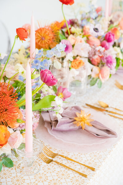 bright colorful flowers on a patterned linen covered table