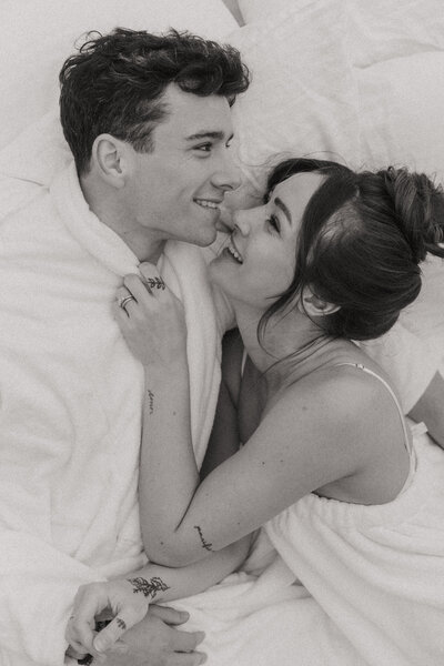 black and white photo of man and woman smiling and embracing