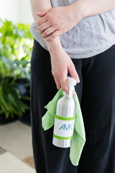 Professional cleaner with AMK multi-purpose cleaning spray