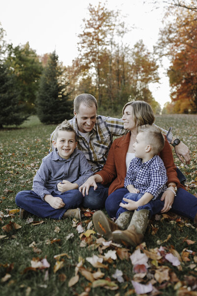 Verona B Photography captures a beautiful fall family photo of a mom, dad, and their two boys at Silver Creek metro Park in Norton, OH. The fall leaves were really at peak color and the sun was perfect for this family photo session near Akron.