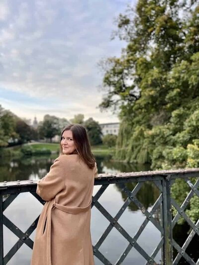 Melissa standing on a bridge looking over her shoulder