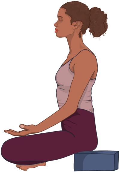 Woman sitting on yoga block