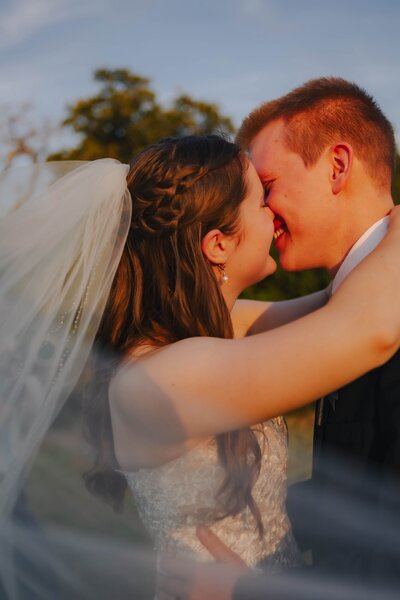 bride and groom share a kiss at their wedding in dallas texas