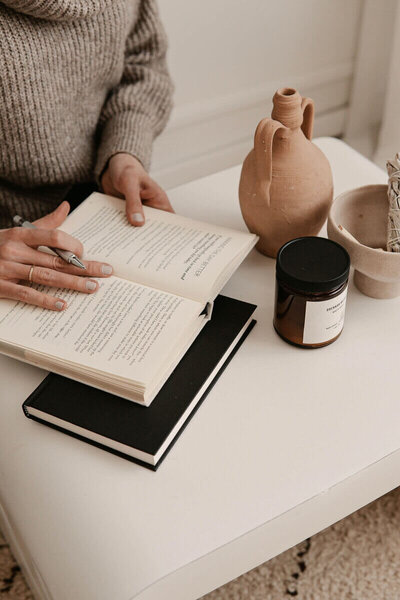 Book on table with a  Modern Life Coach student reading