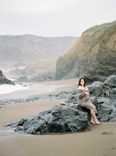 Pregnant mama poses on the beach rocks for San Francisco maternity portraits