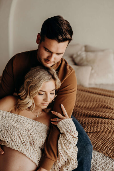 First time parents cuddle before baby comes