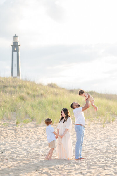 Jessica Jeremiah Photography portrait of family on the beach by the Fort Story Lighthouse