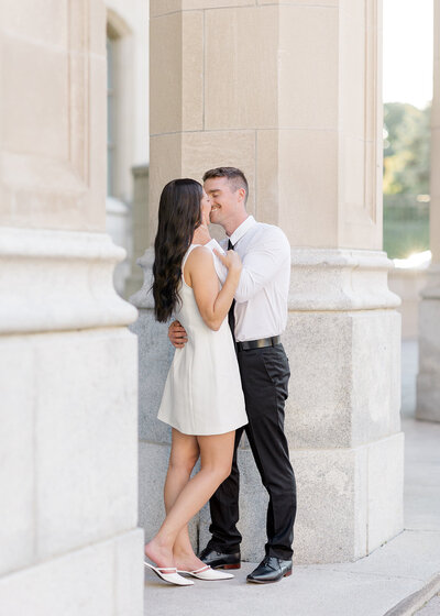 Black and white portrait of a bride and groom kissing at National Arts Centre in Ottawa