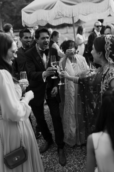 Wedding photographer captures couple taking a stroll hand in hand at their french chateau wedding.