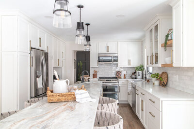 Neutral transitional kitchen with waterfall marble island and white cabinets designed by SC interior designer Haven + Harbor