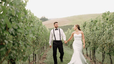 Couple Runs Through Vineyard At Veritas Vineyards