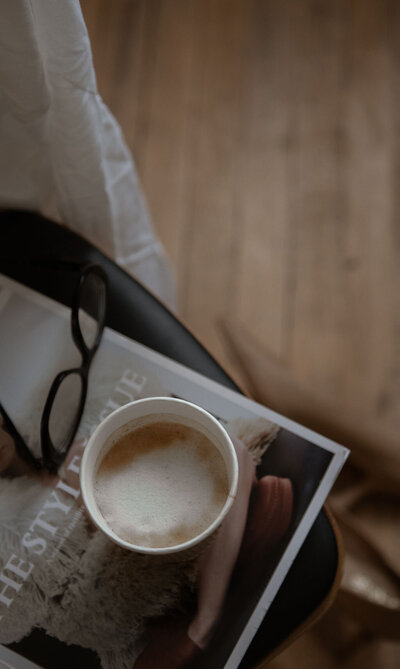 Warm and moody stock collection with takeout coffee cup and magazine