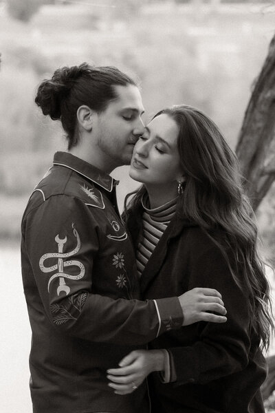 Engaged couple kissing.