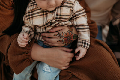 Photo of a mother holding her child during their faily photoshoot in bloomington indiana.