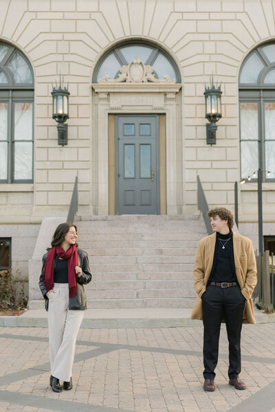 Timeless, winter engagement photos in Old Town Fort Collins with couple standing apart looking at each other
