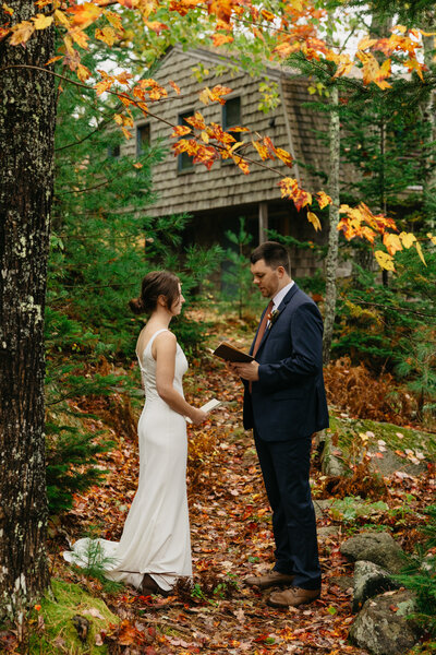 bride and groom in fall foliage