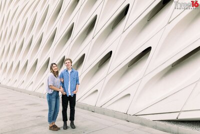 Bride to be holds her Groom's arm during engagement session in front of The Broad in Los Angeles