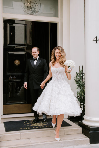 Bride in a bespoke Galia Lahav wedding dress and groom in a black tuxedo at The Arts Club, London, inspired by 90's supermodel style.