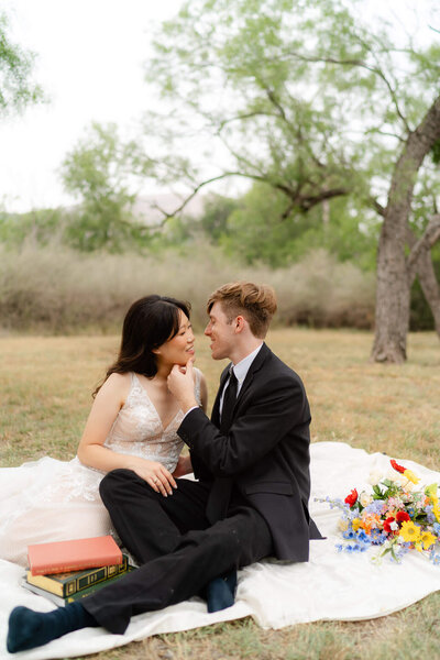 couple on a picnic blanket in Enchanted Rock State park after their adventure elopement