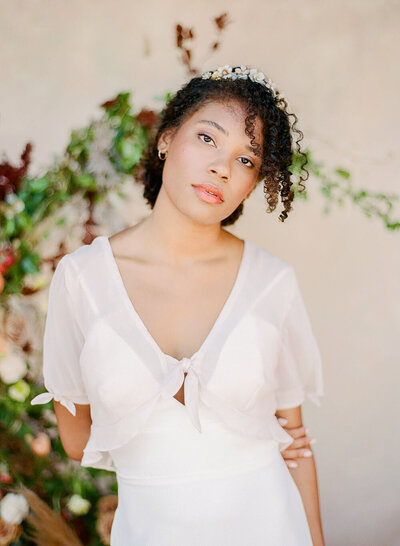 Effervescent bridal hair and makeup from Wild Ivory Beauty with peachy lips and a loose swept-up ‘do