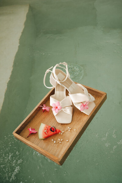 Brides velvet heels hanging from a chandelier