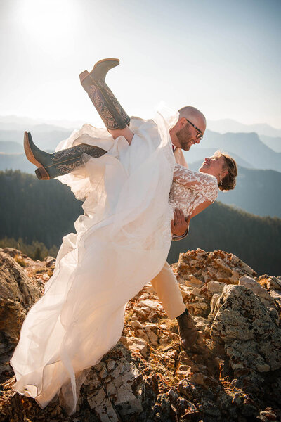 A bride and groom dance in the mountains of Glacier National Park in Montana.