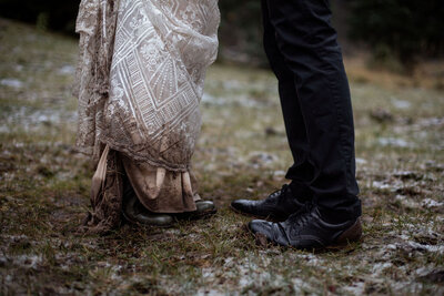 “Close-up of bride and the dirty hem of her gown during an outdoor Utah elopement, photographed by Lamblight Photography