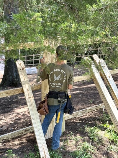 Heron Building Co Employee Installing wood fece in Franklin TN