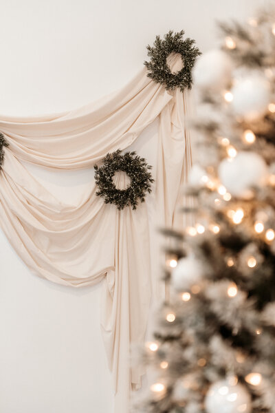 Mother looks down at daughter, daughter is looking at camera