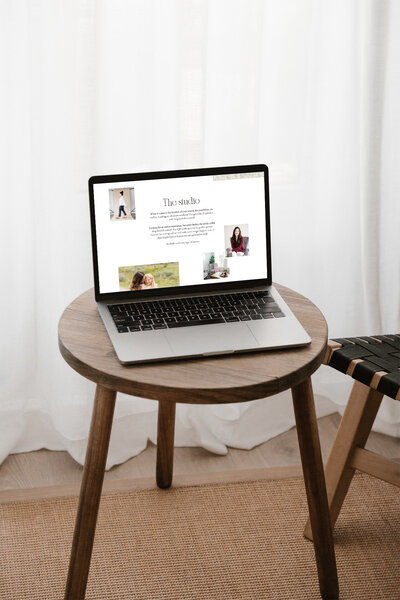 Laptop on stool in front of a curtain