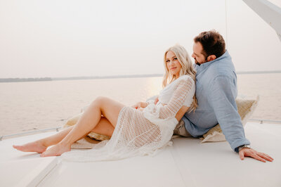 The couple is having an intimate moment and posing for photo. shot on the deck of an yacht. Toronto Wedding Photographer