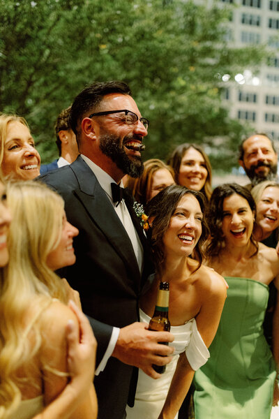Groom gently adjusting bride’s veil at Carnahan Gardens in Jefferson City, capturing an intimate, authentic, and emotional wedding moment in documentary style.