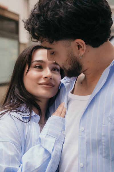 A woman leans dreamy against her boyfriend while looking into his eyes. Couple Photographer Los Angeles.