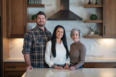 family standing in kitchen smiling