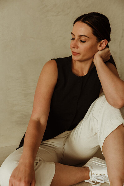 Massage therapist personal brand photoshoot. Owner sitting deep in reflective thought.